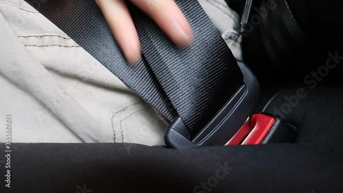 A married adult man fastening his seal belt for his safety and for the safety of his family