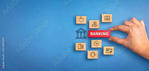 hand holding a wooden block with text Banking with banking services icons. Banking concept, Banking background.