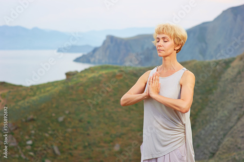 Senior woman doing yoga exercises