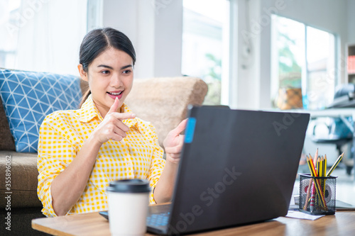 An Asian woman conducts an online meeting