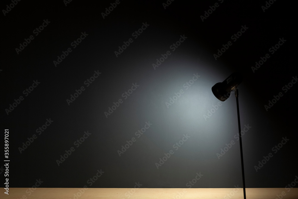 Background with lamps on a desk and a black wall Background with lamps on a desk and a black wall