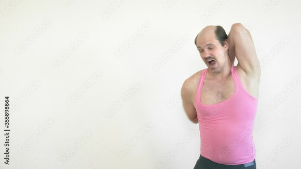 handsome cheerful balding man goes in for sports at home handsome cheerful balding man goes in for sports at home