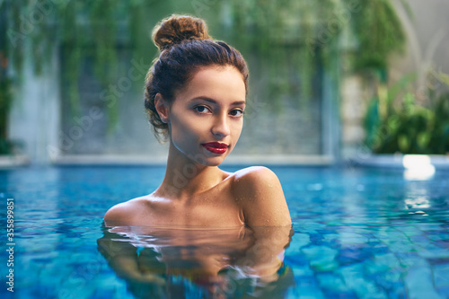 Retreat and vacation.. Beautiful young woman relaxing in spa swimming pool.