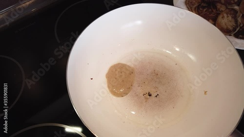 A close-up of pancakes that are frieding in a frying pan photo