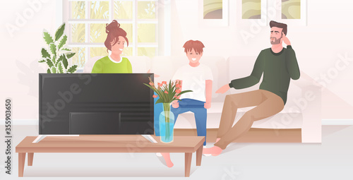 parents with little son watching tv show family sitting on couch spending time together modern living room interior horizontal full length vector illustration