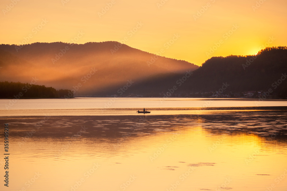 sunset on the sea with a boat and mountains sunset on the sea with a boat and mountains