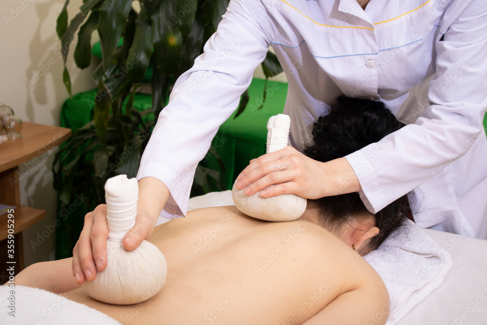 Obraz premium Tea in cotton pouches massage concept. Herbs in spa