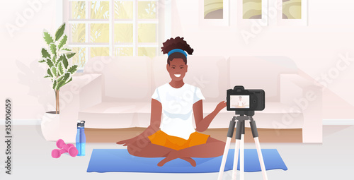 woman fitness trainer recording video blog using camera on tripod live streaming social media network blogging workout concept living room interior horizontal full length vector illustration
