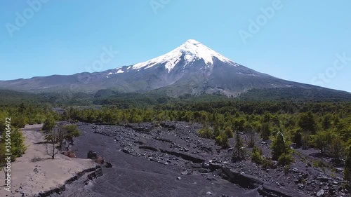Aerial drone footage of Osorno Volcano located in Chilean Andes. Most active volcano in Chile. Volcanic ashes, desert arid climate and snow caped peak of volcano. Similar to Mount Fuji. Chile.