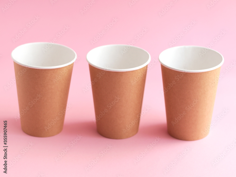 disposable paper cup on pink background. ecology, environmental pollution by plastic, waste recycling concept. flatlay disposable paper cup on pink background. ecology, environmental pollution by plastic, waste recycling concept. flatlay