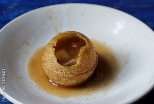 Close Up of Panipuri or Golgappa Stuffed with Tamarind Chutney and Spicy Potato Paste in a Plate, Also Known as Phuchka, Pani Patashi, Gup Chup photo