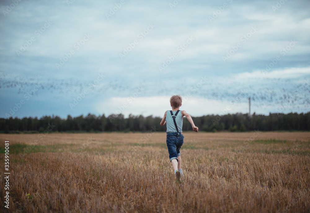a boy running in the field a boy running in the field