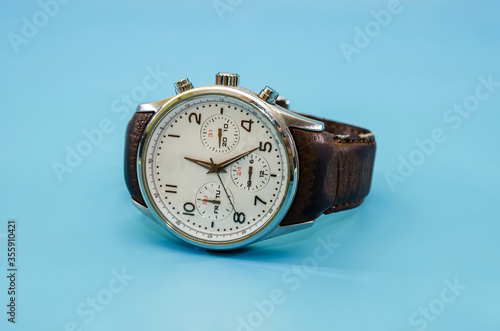 men's wristwatch isolated on a blue background. Close-up.