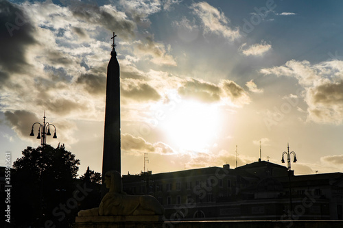 silhouette in backlight of Piazza del Popolo square with obelisk in Rome. Italy
