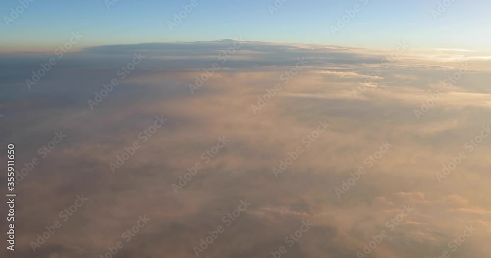 Flying between clouds, view from plane window during flight Flying between clouds, view from plane window during flight