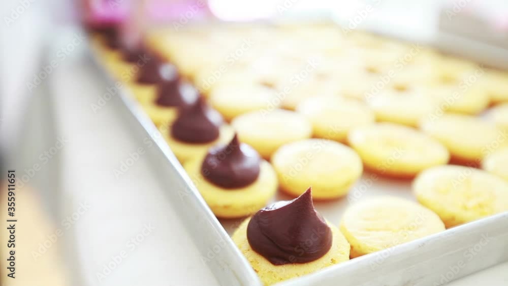 delicious french cake making macarons shells with chocolate cream, small business concept delicious french cake making macarons shells with chocolate cream, small business concept
