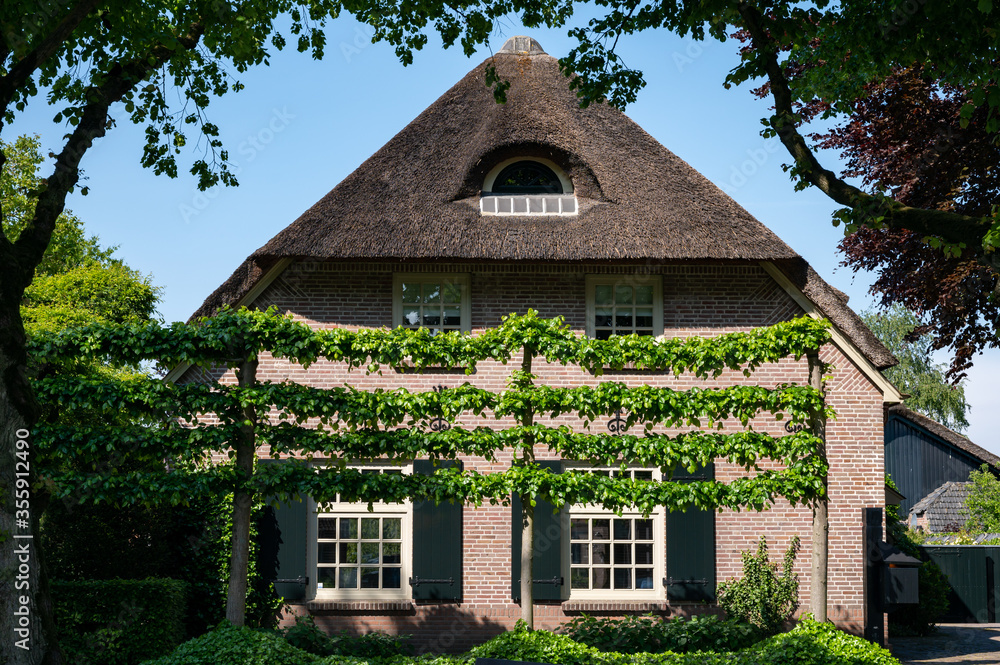 View on old Dutch house with thatched roof in North Brabant, Netherlands View on old Dutch house with thatched roof in North Brabant, Netherlands