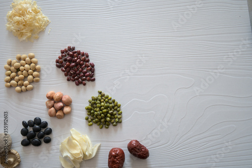 Various beans and ingredients on white background, healthy eating