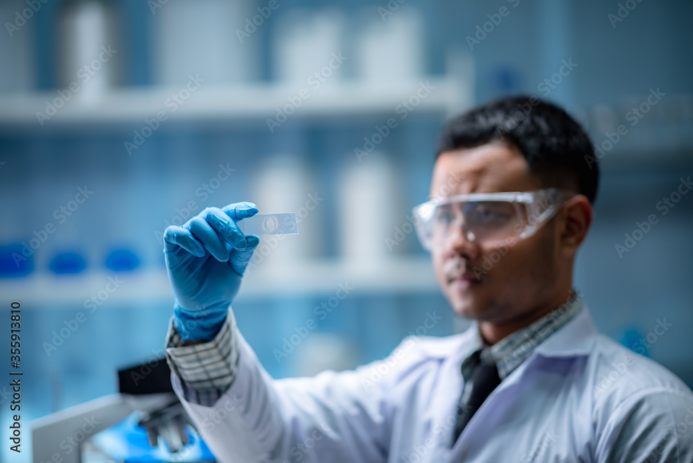 medical science technology research in chemical laboratory, professional scientist working for experiment test in healthcare medicine work with glassware equipment and blue liquid medical science technology research in chemical laboratory, professional scientist working for experiment test in healthcare medicine work with glassware equipment and blue liquid