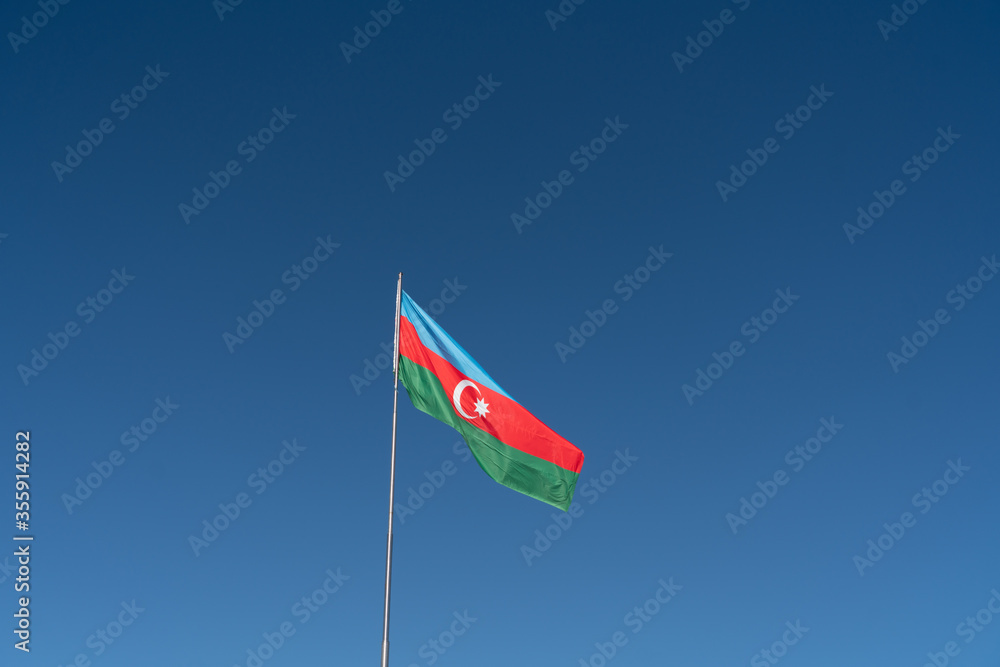 Naklejka premium red flag on blue sky