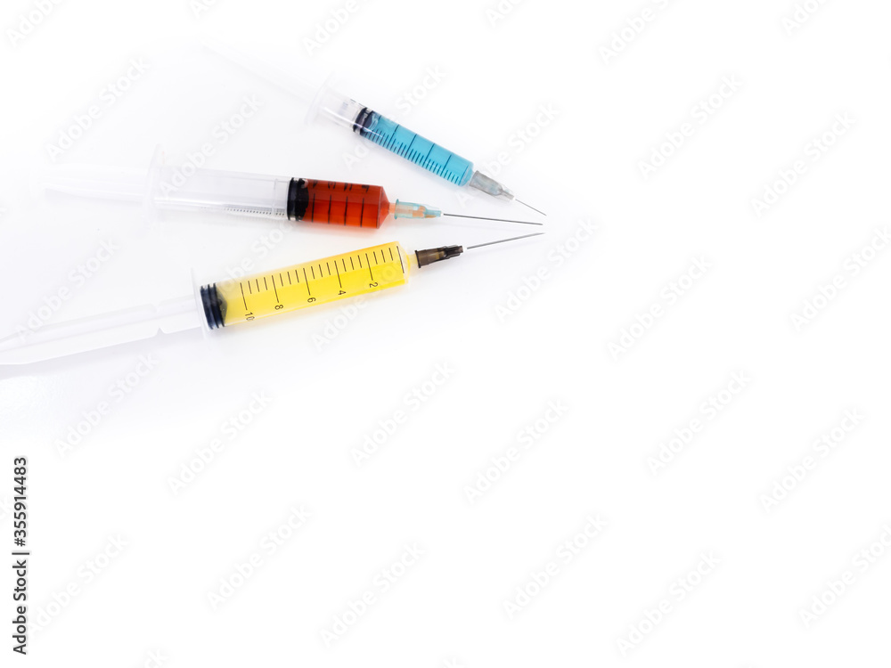 3 syringes, with liquid medicine inside, placed on a white background 3 syringes, with liquid medicine inside, placed on a white background
