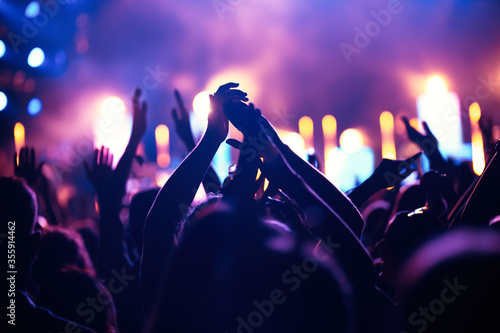 Cheering crowd with hands in air at music festival Fototapeta
