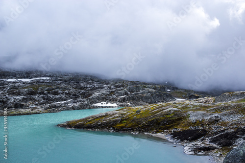 heavy clouds over the lake in the mountains of Norway 