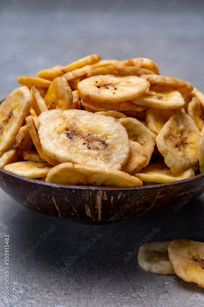 Healthy snack, crispy dehydrated unsugared banana chips in bowl