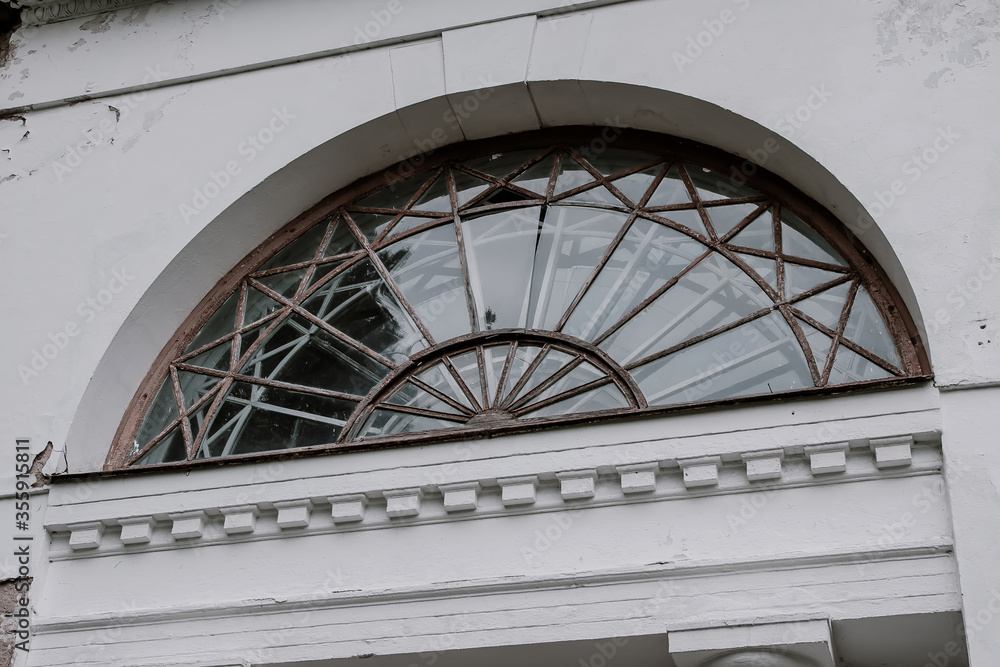 Fototapeta premium Beautiful old window on an old abandoned manor 