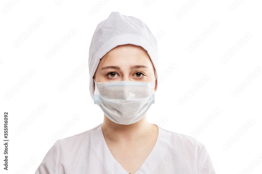 Young girl doctor in a white medical coat, hat and mask. Precautions during the period of the epidemic of coronavirus. Isolated on a white background. Close-up. Young girl doctor in a white medical coat, hat and mask. Precautions during the period of the epidemic of coronavirus. Isolated on a white background. Close-up.