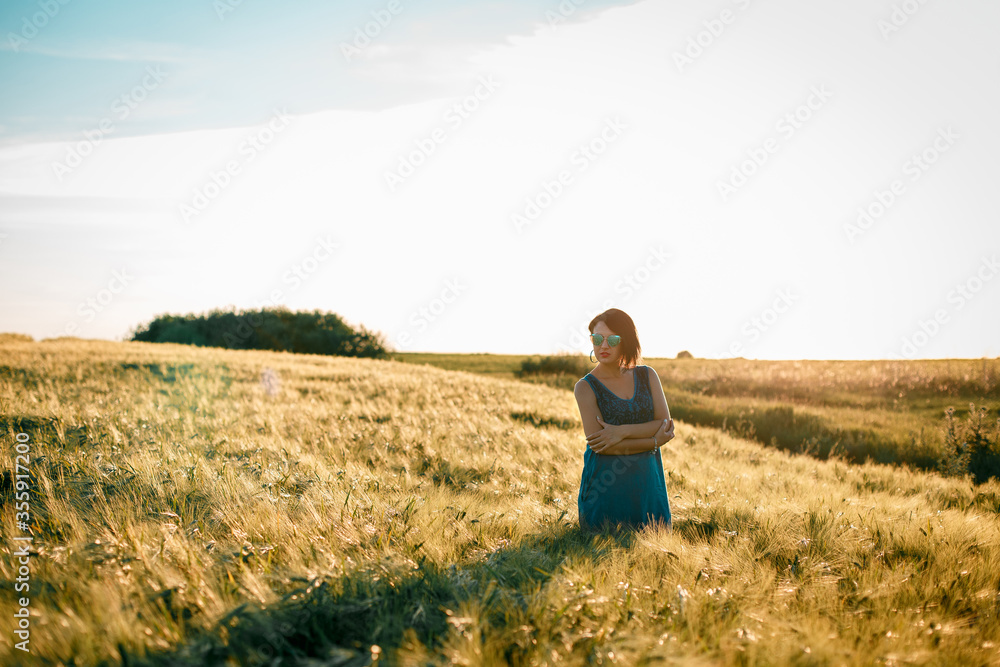Happy woman enjoying the life in the golden field