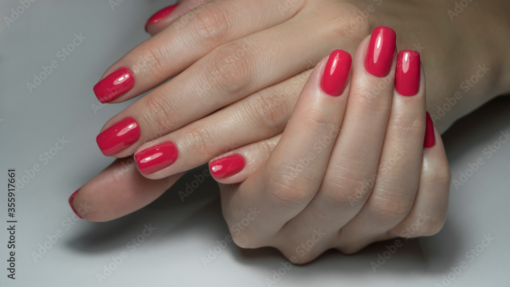 Close up view of female hands with red manicure. Classic red manicure, concept of beauty salon, nails polish. Close up view of female hands with red manicure. Classic red manicure, concept of beauty salon, nails polish.