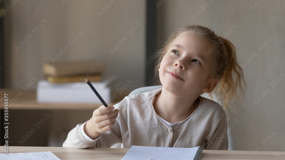 Dreamy little girl sit at desk studying look in distance visualizing or thinking, small child dreamer feel unmotivated distracted from preparing doing homework at home, lost in dreams or imagination Dreamy little girl sit at desk studying look in distance visualizing or thinking, small child dreamer feel unmotivated distracted from preparing doing homework at home, lost in dreams or imagination