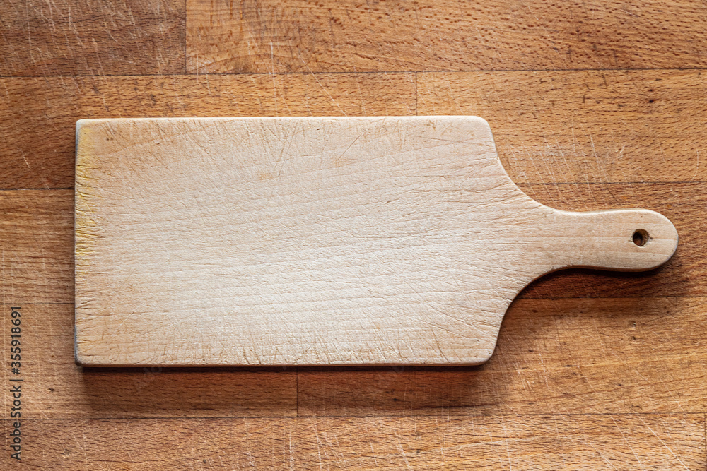 cutting board on wooden counter top cutting board on wooden counter top