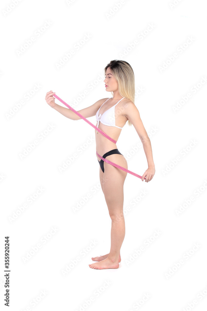 Weight loss background. Proud beautiful fitness woman measuring her body with pants and measuring tape. Weight loss background. Proud beautiful fitness woman measuring her body with pants and measuring tape.