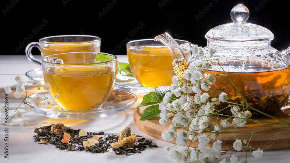 Flower tea with fruit slices. A Cup of green tea and a teapot. Tea ceremony, traditional drink. Afternoon tea, homelike. Flat lay. Oriental, cozy, preparation, heat, tradition, japanese, leafy, herbal Flower tea with fruit slices. A Cup of green tea and a teapot. Tea ceremony, traditional drink. Afternoon tea, homelike. Flat lay. Oriental, cozy, preparation, heat, tradition, japanese, leafy, herbal
