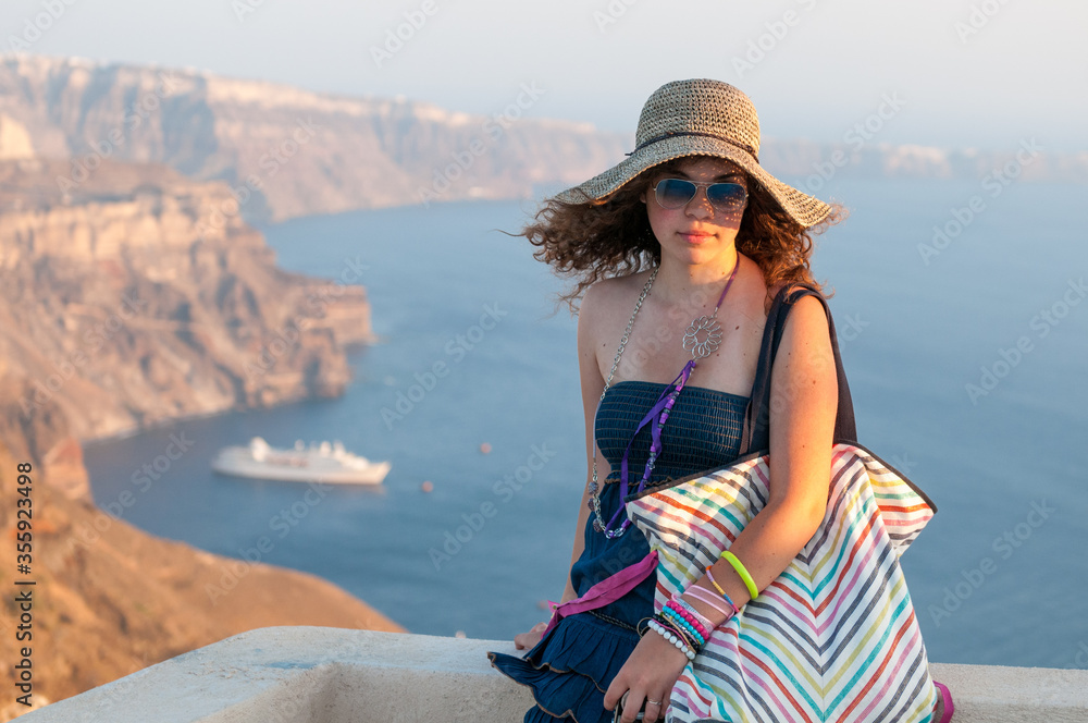 Beautiful happy girl wearing a hat in Santorini Island in Greece.