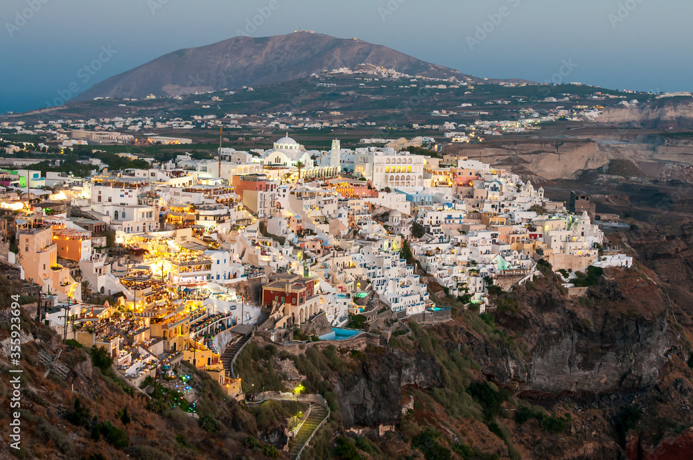 Cityscape of Fira town with white houses and the caldera in Santorini, Greece.