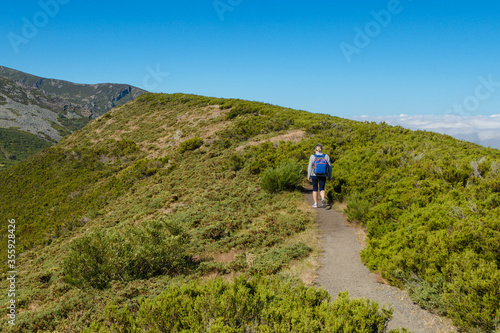 woman tourist with backpack walking on a mountain ridge © sergiy1975