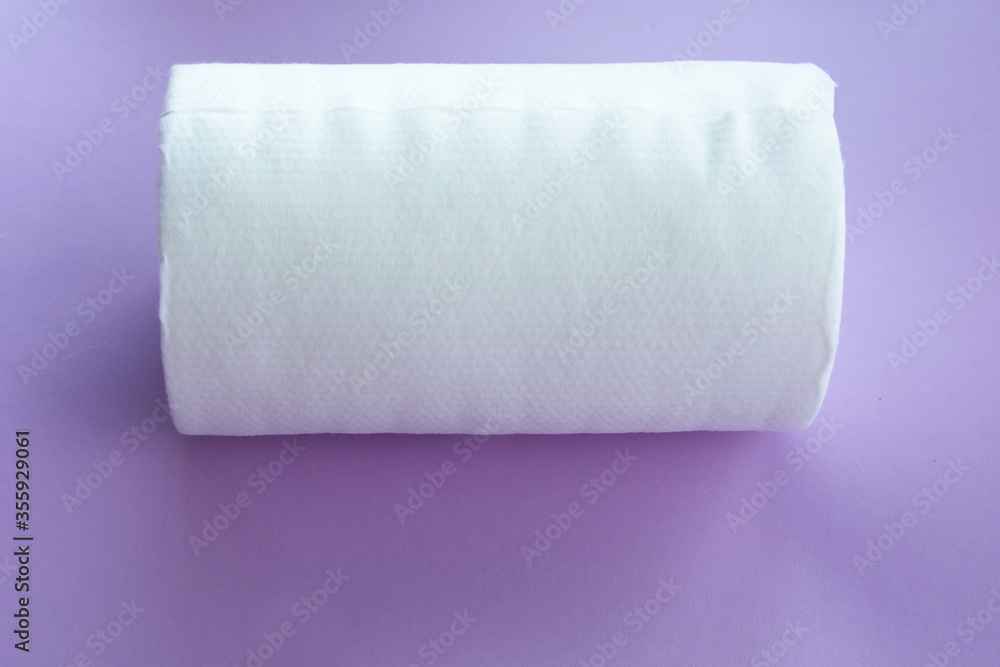 Obraz premium Roll of white disposable nonwoven fabric napkins isolated on pink