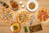 Image of table full of Italian pizzas