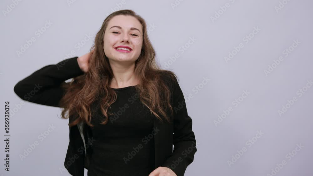 Young Attractive Woman Brunette In In Black T-Shirt And Sweater On White Background, Female Waiting For A Man Looks, Holds Hand To Her Forehead. The Concept Of People Who Missed, Expected Young Attractive Woman Brunette In In Black T-Shirt And Sweater On White Background, Female Waiting For A Man Looks, Holds Hand To Her Forehead. The Concept Of People Who Missed, Expected