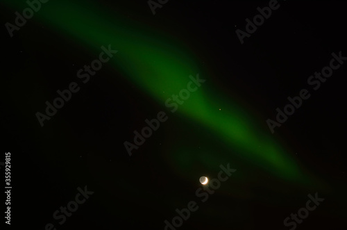aurora borealis and full moon in winter night in the deep arctic circle © Arcticphotoworks