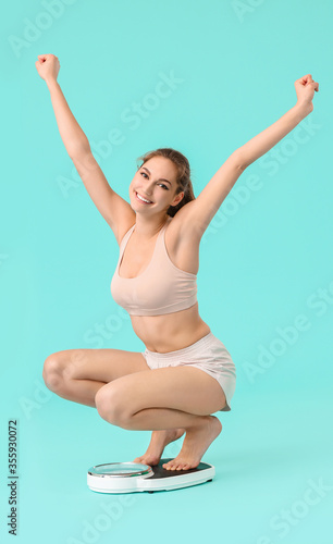 Happy young woman measuring...