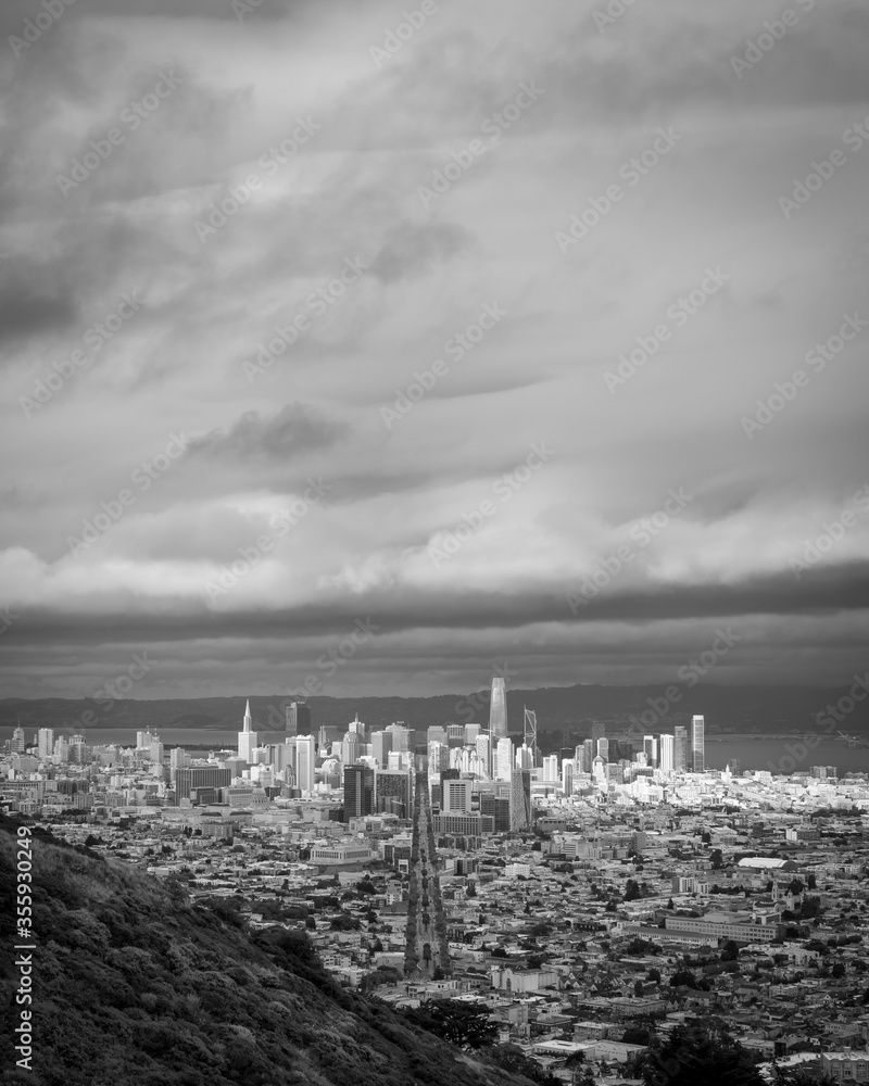 Downtown San Francisco viewed down the length of Market Street from Twin Peaks.  Cloudy day, dramatic clouds.