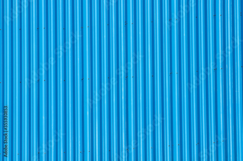 Light blue metal striped corrugated fence or building wall