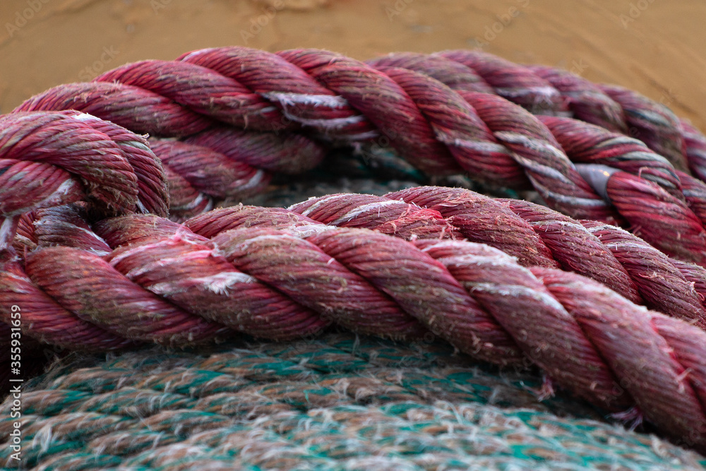 Detail of a rough and worn ropes on a large spool.