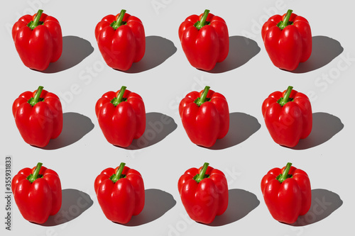Colourful pattern of bell peppers on grey background. View from top.