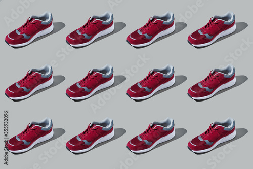 Colourful pattern of sneakers on grey background. View from top.