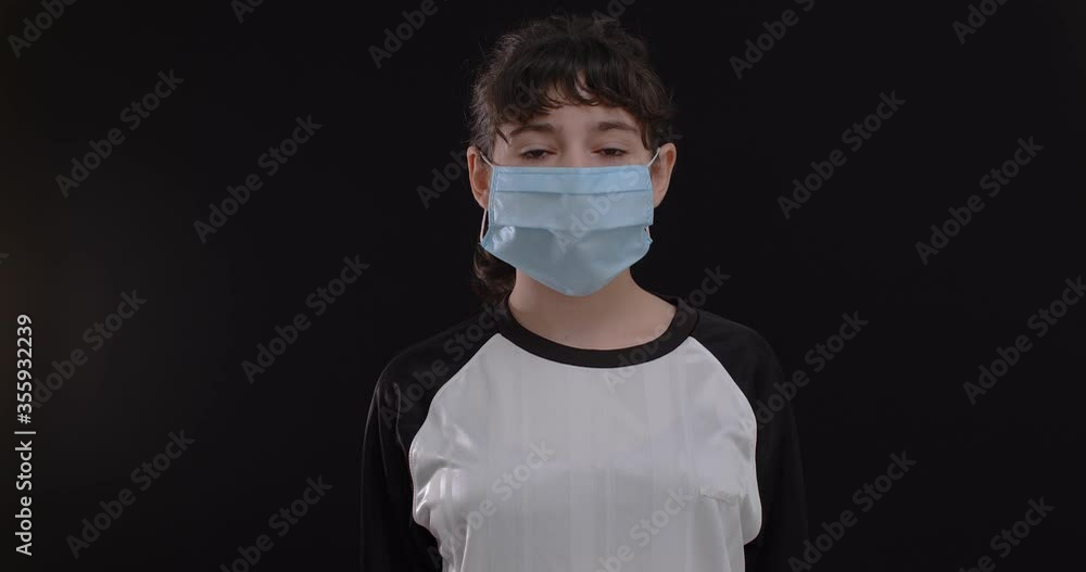 Portrait of a teenage girl footballer with protective masque and football soccer ball on black background, 4k Portrait of a teenage girl footballer with protective masque and football soccer ball on black background, 4k